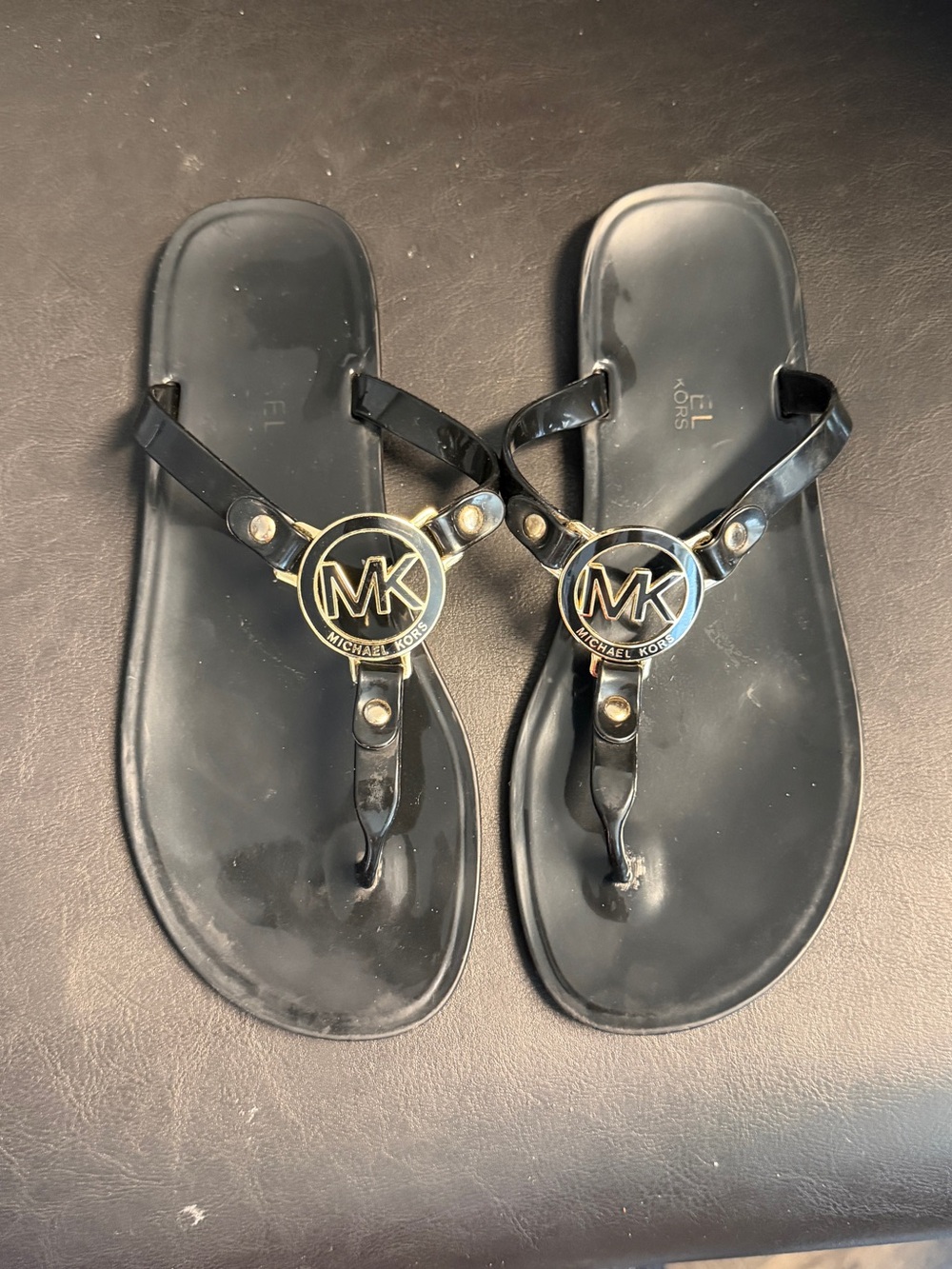 Michael Kors Black Patent Jelly Logo Thong Sandals with Gold MK Medallions
